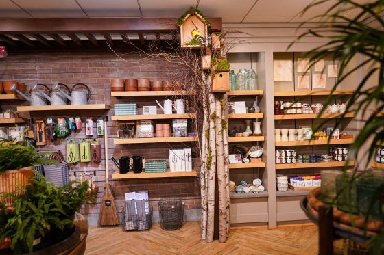 Displays in the Garden Shop featuring planters and birdhouses.